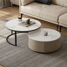 two tables sitting on top of a rug in front of a couch and coffee table