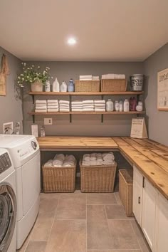 a washer and dryer in a small room with shelves above the washer