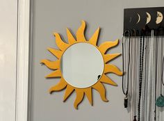 a sun shaped mirror hanging on the wall