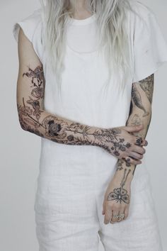 a woman with tattoos on her arm and arms