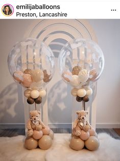 two clear balloons with teddy bears in them on top of a white fluffy rug next to each other