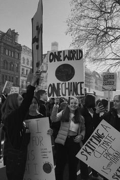 a group of people holding signs in the street