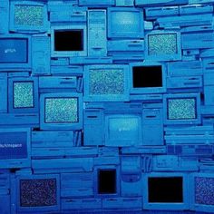 many televisions are stacked on top of each other in the same blue color scheme