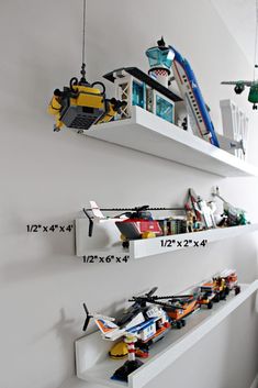 two shelves with legos on them are hanging from the wall