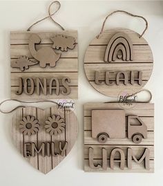 three wooden plaques with the words, name and animals on them are hanging from twine strings