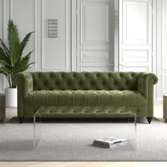 a living room with a green couch and coffee table in front of the wall,