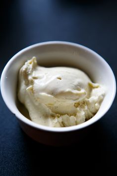 a white bowl filled with mashed potatoes on top of a table