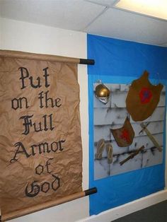 two banners hanging on the wall next to each other with words written in black and gold