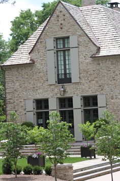 an old brick house with stone steps leading up to it