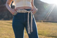 Embrace bohemian charm with our beige rope waist tie belt featuring exquisite beading accents. This versatile accessory adds a touch of natural elegance to your outfit. The neutral beige color complements a variety of looks, while the beading accent provides a unique and stylish flair. Crafted with attention to detail, this rope belt allows you to cinch your waist in style. Elevate your fashion statement with our boho chic beige rope waist tie belt – a perfect blend of trendy and timeless. Adjustable Beige Belt For Spring, Spring Adjustable Beige Belt, Beige Adjustable Belt For Spring, Spring Beige Rope Belt, Adjustable Beige Belt For Summer, Embroidered Belt For Summer Beach, Adjustable Bohemian Fabric Belt, Adjustable Belts For Spring Festival, Adjustable Beige Rope Belt