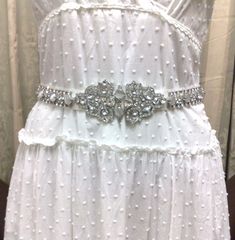 "A unique geometric bridal sash, inspired by Art Deco 1920s Gatsby wedding style. This wedding belt is made of top grade rhinestone crystals and simulated cat's eye gemstones, set onto a tie-back double-sided satin ribbon base, plus more crystals at both ends for added blings. Sash total length (crystal plus ribbon) is 78\" or 200cm. Crystal is about 19 1/2\" (49.5cm) long, 2 1/8\" (5.4cm) wide. Ribbon is 1\" (2.5cm) wide. View all sash belts at https://etsy.me/1aLToLU" White Gatsby Style Wedding Dress, Silver Vintage Wedding Dress, White Gatsby Wedding Dress, White Wedding Dress With Sashes, Vintage Silver Wedding Dress, Elegant White Sashes For Mother Of The Bride, Elegant White Sash For Mother Of The Bride, Fitted Sashes Bridal Belt For Wedding, Fitted Bridal Belt With Sashes For Wedding