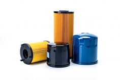 three different types of oil filters on a white background, one is blue and the other is yellow