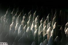 a large group of people standing in the dark