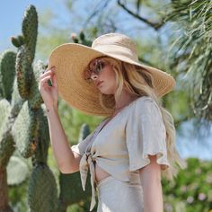 A true gem of a find! This Raffia style hat keeps you cool and out of the sun. Makes for a great go to when you head over to the beach or while reading by the pool. With an added touch of a faux suede band, this hat will be one of your favorites. Features: 6" Brim UPF 50+ Adjustable 100% Raffia Women's one size Faux Suede Band Raffia Braid Wide Brim Summer Fedora Panama Hat Made Of Palm Leaf, Chic Straw Sun Hat For The Beach, Chic Straw Sun Hat For Beach, Chic Straw Hat For Beach, Chic Woven Sun Hat For Vacation, Beachwear Sun Hat For Vacation, Summer Coastal Straw Hat, Coastal Summer Straw Hat, Coastal Style Summer Straw Hat