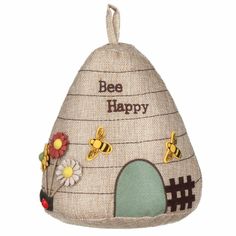 a burlock with bees and flowers on it that says bee happy in front of a house