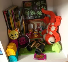 there are many toys and books on the shelf in this room, including an orange stuffed animal