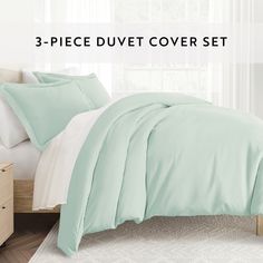 the 3 piece duvet cover set in mint green is shown with white sheets and pillows