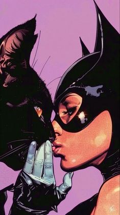 a woman in catwoman costume kissing a black cat