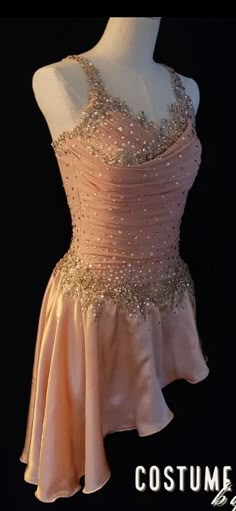 a mannequin wearing a pink dress with sequins on it