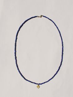 A tiny amulet with a re-imagined ancient charm strung on lapis beads. 22k gold charm on lapis beaded necklace, measures 18” long. Takara Design is a women-owned, small business based in Oregon. Lapis Bead Necklace, Lapis Beaded Necklace, Traditional Lapis Lazuli Necklace With Gemstone Beads, Lapis Lazuli Gemstone Beads Pendant Necklace, Elegant Beaded Lapis Lazuli Necklace, Spiritual Lapis Lazuli Pendant Beaded Necklace, Lapis Lazuli Amulet For Meditation, Blue Lapis Lazuli Amulet Jewelry, Lapis Necklace