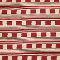 a red and white striped rug with small squares on it's sides, in the middle