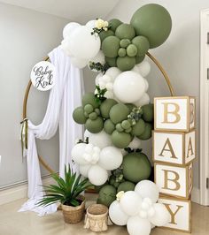 a baby shower with balloons and greenery