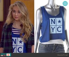 a woman wearing a blue tank top with the words nyc on it and an image of a