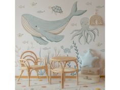 a child's room decorated in blue and white with an octopus mural on the wall