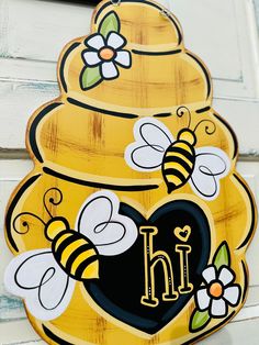 a painted beehive with the letter h on it