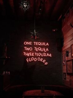 a neon sign that reads one tequila two tequila three tequila