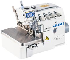 the juki sewing machine is white and has blue letters on it's side