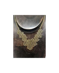 The geometric Honeycomb necklace is the Bees Knees! This necklace is 24"-26" made of brass, the perfect elegance to add to your ensemble. Brass jewelry cleans easily and using any brass cleaner. The perfect statement piece to add to the your collection. Honeycomb Necklace, Festival Jewelry, Bees Knees, Brass Jewelry, Bohemian Jewelry, Cleaning Jewelry, Honeycomb, Statement Pieces, Cuff Bracelets