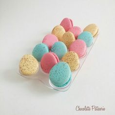 there are many different colored macaroons in the tray