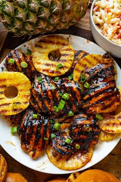 grilled pineapples and macaroni salad are served on a white plate