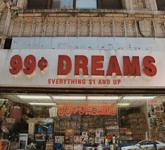 there is a sign that says 99 degrees dreams in front of a storefront window