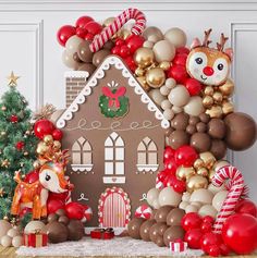 a gingerbread house is decorated with balloons and other holiday decorations for the holiday season