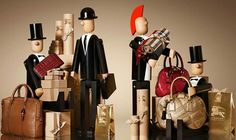 two figurines are stacked on top of each other with bags and purses