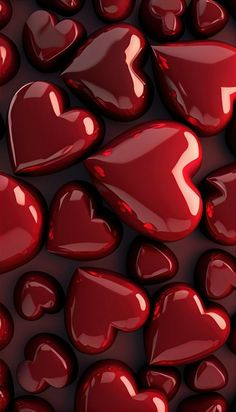 many red hearts are arranged in the shape of heart shapes on a dark background with light reflections