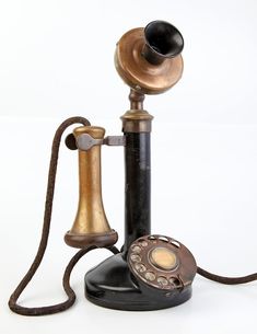 an old fashioned phone with a cord attached to it