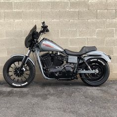 a motorcycle parked in front of a brick wall