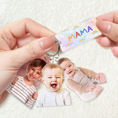 a person holding a keychain with two photos on it and the words mama