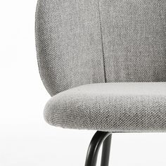 an upholstered chair with black metal legs and a light gray fabric seat cover