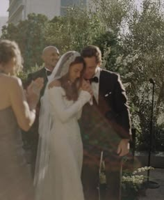 a bride and groom standing next to each other in front of an outdoor wedding ceremony