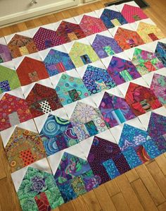 a colorful patchwork quilt is laying on the floor