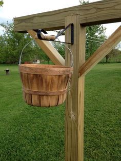 a bucket hanging from the side of a wooden structure