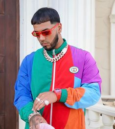 a man wearing sunglasses and a colorful jacket