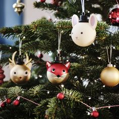 christmas ornaments are hanging from the branches of a tree