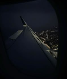 the wing of an airplane at night as seen from inside the plane's window