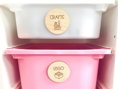 two white and pink containers with wooden labels on the lids are shown in this image