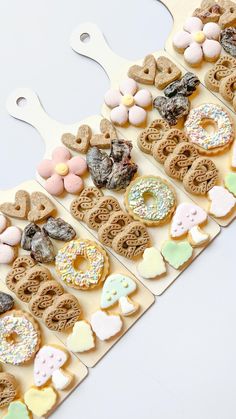 a bunch of cookies that are on a white board with holes in the middle to make them look like doughnuts and pretzels